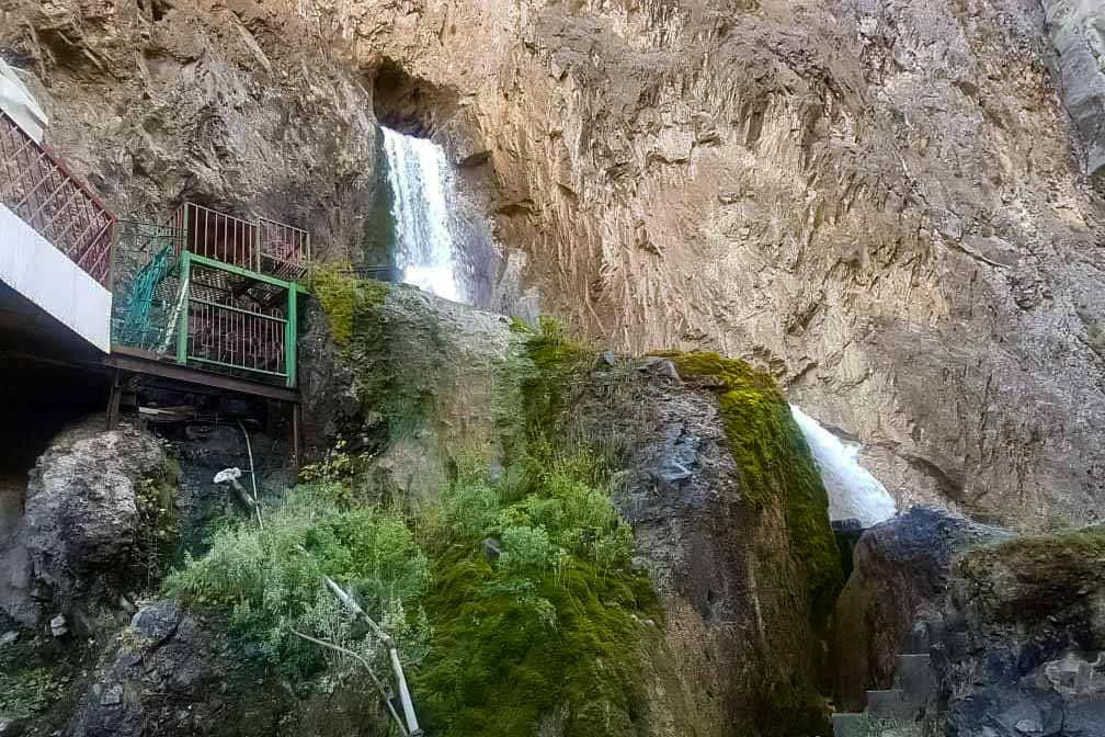 Abshir Ata waterfall coming out from the hole in the rock in the Southern Kyrgyzstan