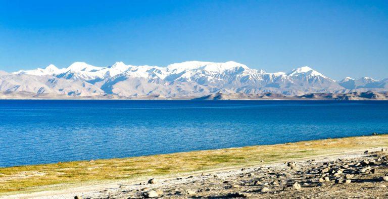 Karakul lake by the Pamir highway. View on the lake and Peak Lenin near Karakul village in the Pamirs, Tajikistan, Central Asia.