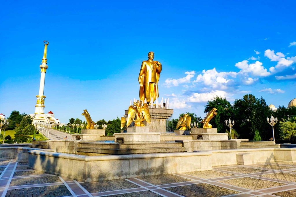 Ashgabat independence park with golden president statue and the monument of indepencence