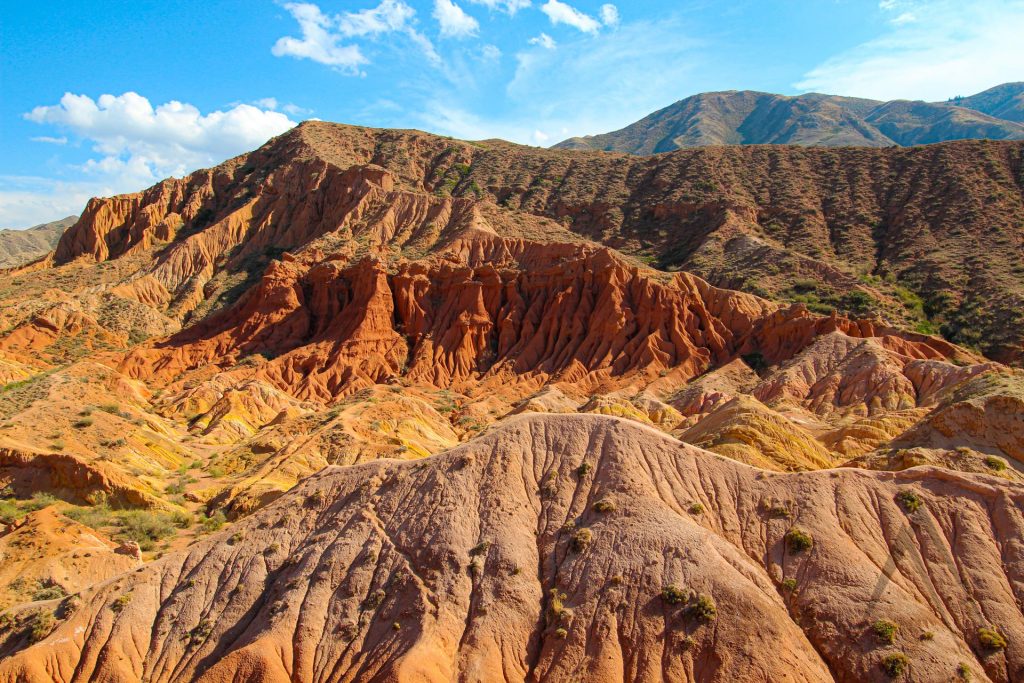 Orange stone humanlike characters in Skazka Fairytale canyon near Issyk Kul in Kyrgyzstan