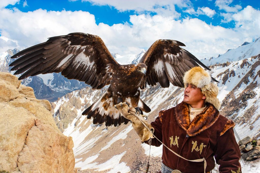 Kyrgyzstan eagle hunting with mountains in the background