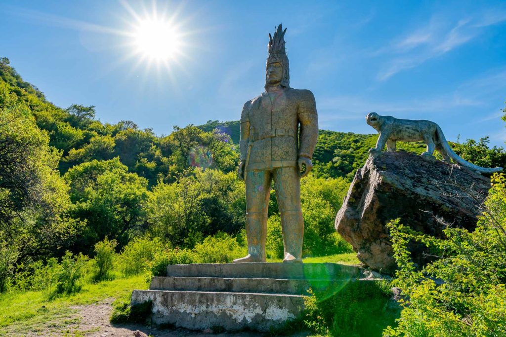 Esik Issyk Turgen Gorge Picturesque View of Sakian Soldier Golden Man and Snow Leopard Statue on a Sunny Blue Sky Day
