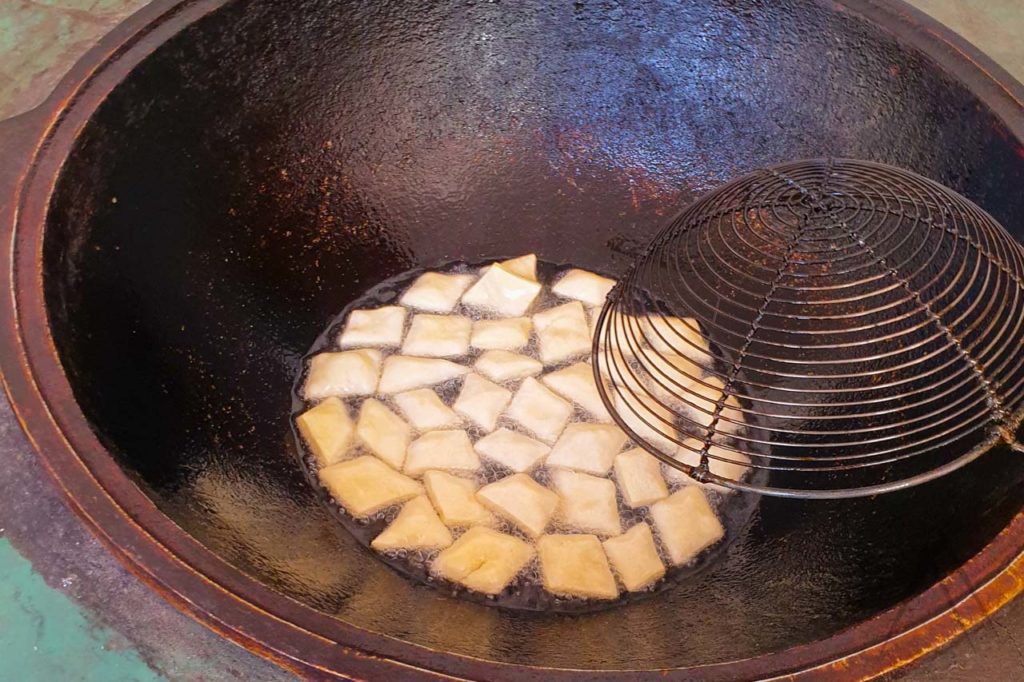 Frying boorsok in a kazan pan