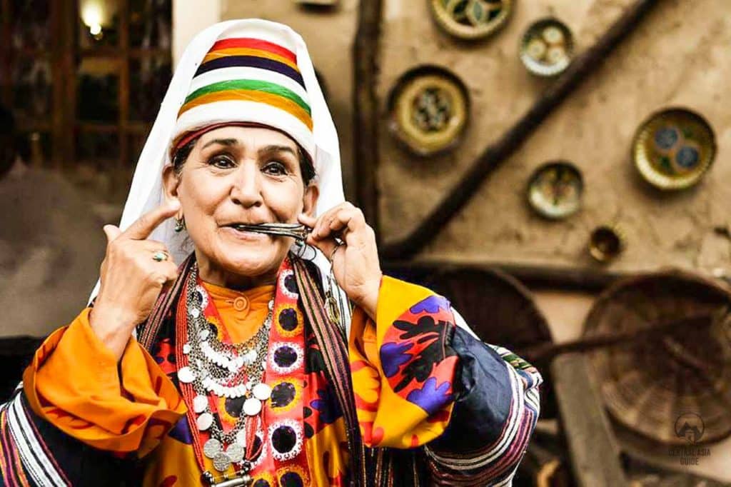 Uzbekistan Navruz tour celebrations old woman playing mouth instrument