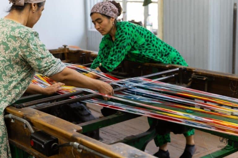 Women working with silk production in Yodgorlik silk factory in Margilan