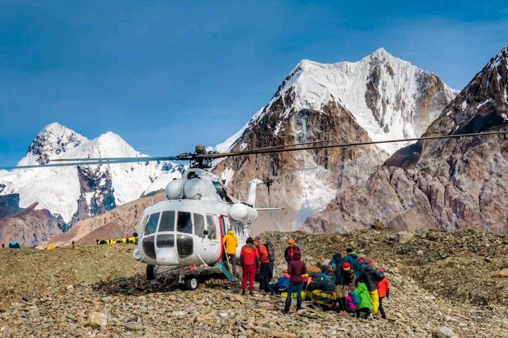 Trekking tour group collected by a helicopter near Enilchek glacier