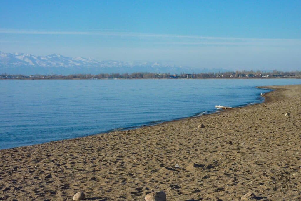 Balykchi beach with Tien Shan mountains behind Issyk Kul